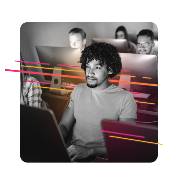 Close-up of a group of people working at their laptops.